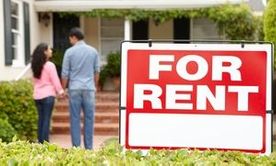 Hispanic couple outside home for rent