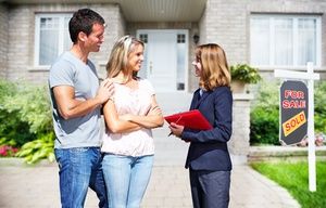 Real Estate agent woman with clients near new house.