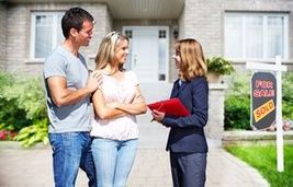 Real Estate agent woman with clients near new house.